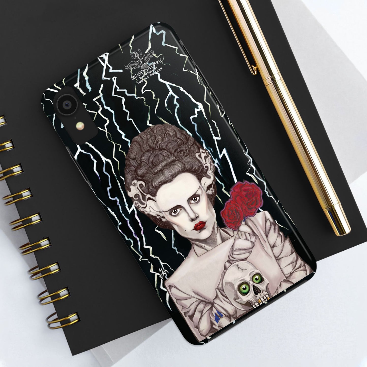 ELECTRIFY Those Around You with A Bride even the LIVING can be Bewitched By.... Let Them Stare at a Tough Phone Case that will Protect Your iPHONE Wherever GO!  Inspired by Universal Studios 1935 Film, The Bride of Frankenstein, starring Elsa Lanchester.   The Corpse Bride of Frankenstein was originally Brought to Life on Canson Paper, via the Mediums of Pen, Marker, Colored Pencil, and Acrylic Paint, by the then Blossoming Artistic Talent of Shakinaart when She was 16 years old.  SHAKINAART's Paintings are