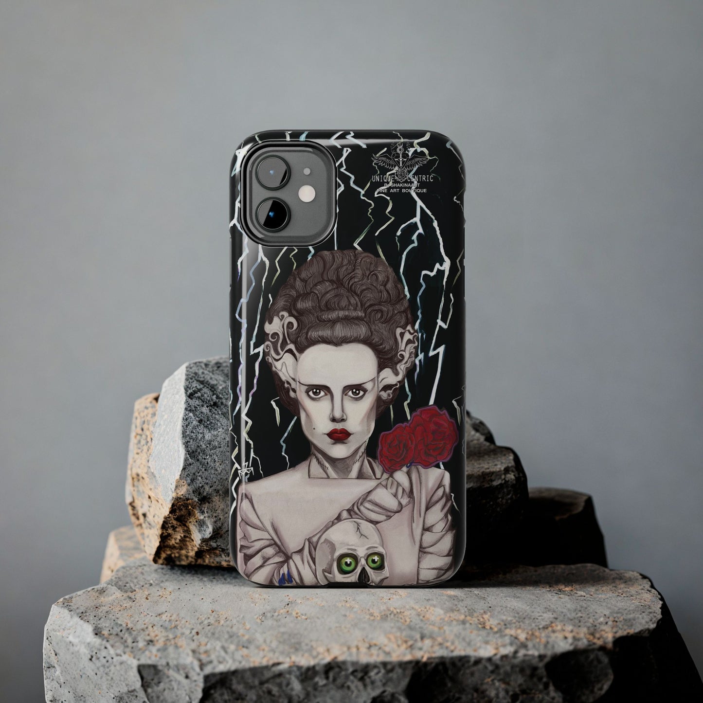 ELECTRIFY Those Around You with A Bride even the LIVING can be Bewitched By.... Let Them Stare at a Tough Phone Case that will Protect Your iPHONE Wherever GO!  Inspired by Universal Studios 1935 Film, The Bride of Frankenstein, starring Elsa Lanchester.   The Corpse Bride of Frankenstein was originally Brought to Life on Canson Paper, via the Mediums of Pen, Marker, Colored Pencil, and Acrylic Paint, by the then Blossoming Artistic Talent of Shakinaart when She was 16 years old.  SHAKINAART's Paintings are