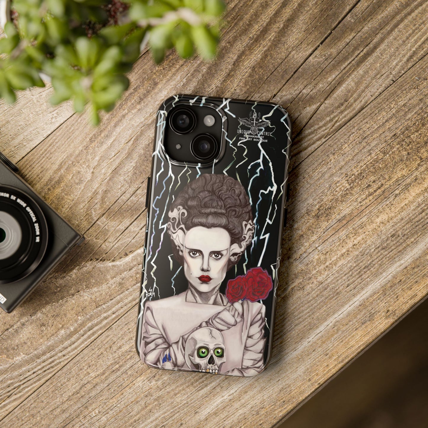 ELECTRIFY Those Around You with A Bride even the LIVING can be Bewitched By.... Let Them Stare at a Tough Phone Case that will Protect Your iPHONE Wherever GO!  Inspired by Universal Studios 1935 Film, The Bride of Frankenstein, starring Elsa Lanchester.   The Corpse Bride of Frankenstein was originally Brought to Life on Canson Paper, via the Mediums of Pen, Marker, Colored Pencil, and Acrylic Paint, by the then Blossoming Artistic Talent of Shakinaart when She was 16 years old.  SHAKINAART's Paintings are